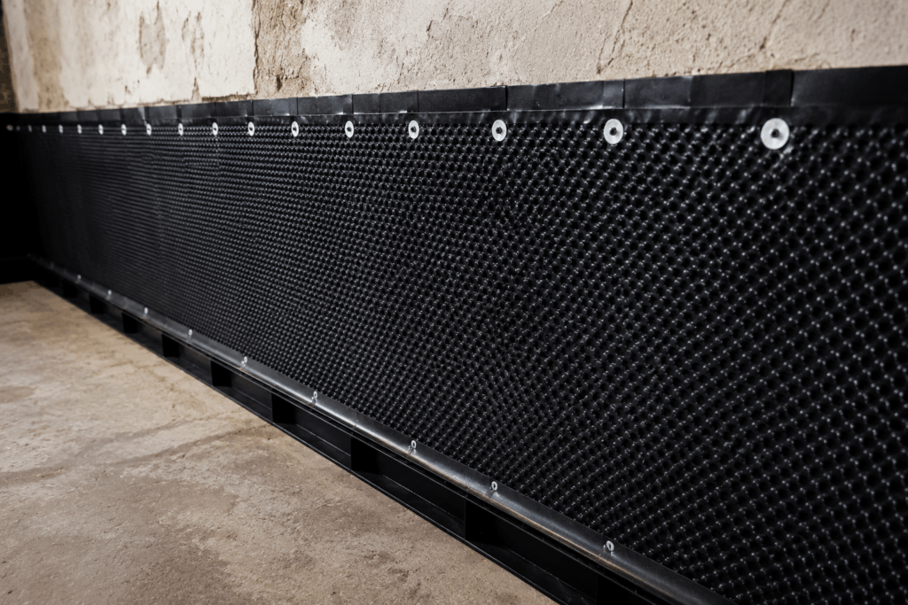 Basement tanking membrane system fixed to cellar walls for effective waterproofing and damp protection.